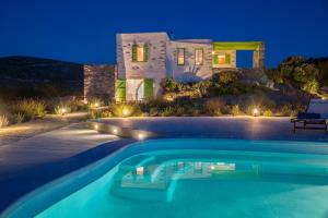 a villa with a swimming pool in front of a house at Villa Aeolos with 2 private pools in Sarakíniko
