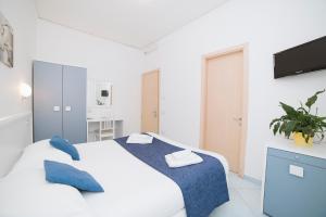 Postel nebo postele na pokoji v ubytování Hotel De Rosa