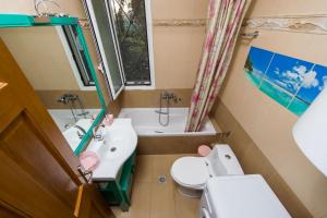 a small bathroom with a sink and a toilet at Boutique Apartment Volos in Volos