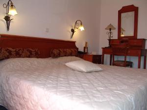 
A bed or beds in a room at Laodamia Hotel
