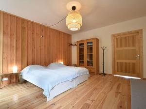 a bedroom with a white bed and wooden walls at Modern apartment in Cuzy with shared pool in Cuzy
