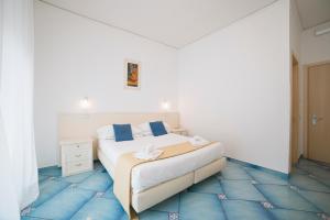 Postel nebo postele na pokoji v ubytování Hotel De Rosa