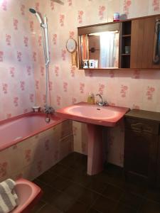 a bathroom with a pink sink and a tub at May's Cottage in Availles-Limouzine +25 photos