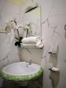 a bathroom with a sink and a mirror at holidays hotel in Dummaladeniya East
