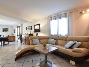 a living room with a couch and a table at Comfy villa near Alvignac with private pool in Alvignac