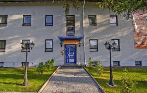 a building with a blue door and two street lights at Mango Hotel in Tampere