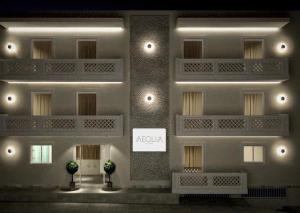 een weergave van een gebouw met een bord erop bij Aeolia suites in Karpathos