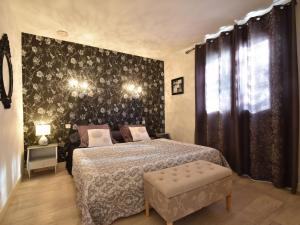 a bedroom with a bed and a black wall at Comfy villa near Alvignac with private pool in Alvignac