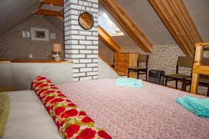 a bedroom with a large bed in a attic at Gaja-Białowieża in Wiluki