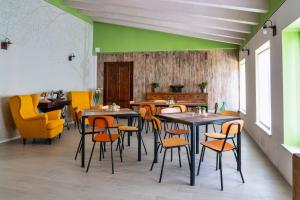 un restaurante con mesas, sillas y paredes verdes en Casa Giardini en Verona