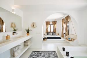 a white bathroom with a bed in a mirror at Le Blanc Resort - Two Luxury Villas in Mesaria
