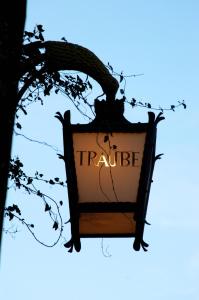 a sign that reads trilleille hanging from a tree at Hotel Traube in Scuol