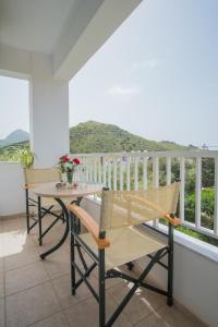 a patio with a table and chairs on a balcony at Kassiani Studios in Plakias