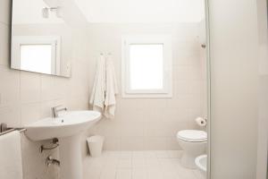 bagno bianco con lavandino e servizi igienici di Marinaio a San Foca