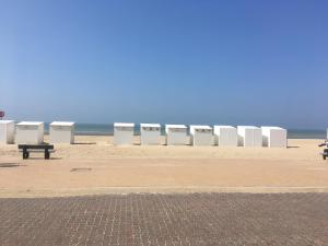 a row of white barriers on the beach at Studio Koksijde in Koksijde +19 photos