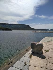 a heart statue sitting on the side of a body of water at Guesthouse Yashima in Takamatsu