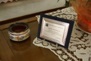 a table topped with a certificate next to a cup of coffee at Afroditi in Panormos Skopelos
