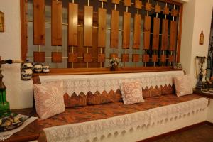 a bench with pillows on it in a room at Afroditi in Panormos Skopelos
