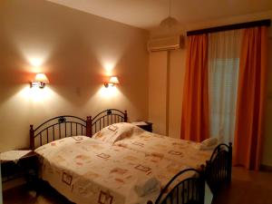 a bedroom with a bed and two chairs and a window at Vrokastro Apartments in Istro