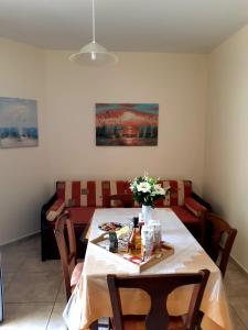 a dining room with a table and a couch at Vrokastro Apartments in Istro