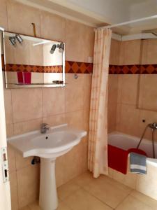 a bathroom with a sink and a tub at Vrokastro Apartments in Istro
