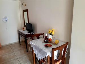 a dining room with a table and a piano at Vrokastro Apartments in Istro
