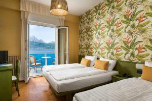 Postel nebo postele na pokoji v ubytování Hotel Caribe - Garda Lake Collection + 28 fotografií