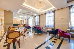 a lobby with chairs and tables in a building at BO Hotel Palazzo in Poreč