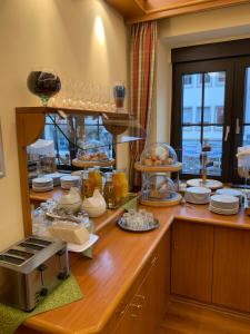 a kitchen with a counter with plates and dishes at Zum Winzermännle in Würzburg