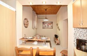 a kitchen and dining room with a table and chairs at BETTY'S HOUSE in Pythagoreio