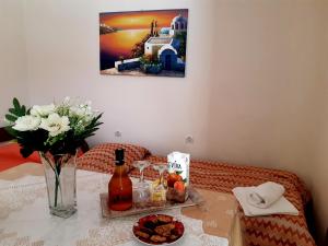 a table with a bottle of wine and a plate of food at Vrokastro Apartments in Istro +37 photos