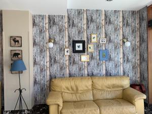 a living room with a couch and a wooden wall at Hotel Arcea Villaviciosa in Villaviciosa