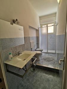 a bathroom with a sink and a toilet at Rooms for rent 67 in Sassari