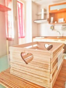 a wooden box with two hearts on top of a table at Oly99 in Palermo
