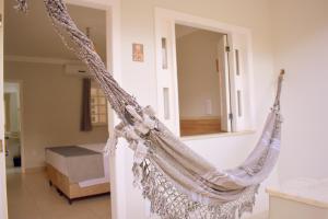 a hammock hanging in a room with a bedroom at Tropical Mar Hotel in Aracaju