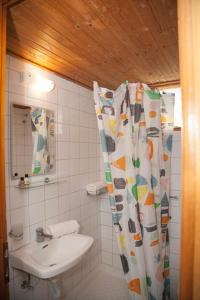a bathroom with a sink and a shower curtain at Gioma Hotel in Agia Galini