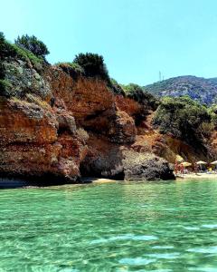 a view of a beach with the water in front of a cliff at Vrokastro Apartments in Istro