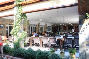 a restaurant with chairs and people sitting at tables at Toloman Hotel Bitez Beach in Bitez