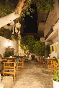 a restaurant with wooden chairs and tables at Gioma Hotel in Agia Galini