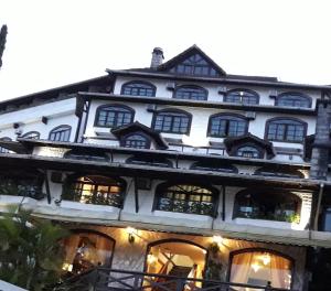 a large white building with many windows at Gallardin Palace Hotel in Petrópolis