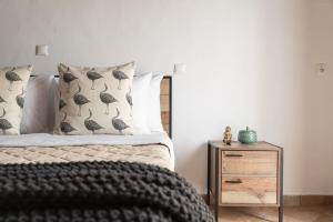 a bedroom with a bed with black and white pillows at Villa Margarita in Anafonítria