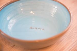 a bowl of soy sauce sitting on a table at Houses at Chrisopigi Sifnos in Chrisopigi