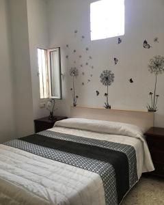 a bedroom with two beds and butterflies on the wall at Hostal Gutierrez in Ceuta