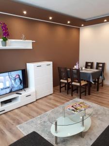 a living room with a tv and a dining table at Apartment TT6 in Trnava