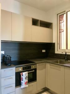 a kitchen with a stove top oven next to a sink at villa juturne in Beausoleil