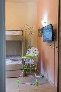 a room with a chair and a tv and bunk beds at Luxury Seaside House in Mades Heraklion in Agia Pelagia