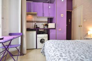 a purple bedroom with a bed and purple cabinets at Apartamentos Marques De La Merced in Málaga