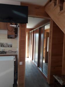 a view of a kitchen with a television and a hallway at Смериковий in Yaremche +17 photos