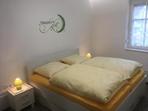 1 cama con 2 almohadas en una habitación en zentral gelegene top ausgestattete Wohnung, en Wurzen