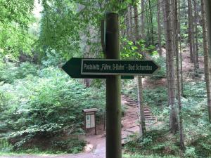 a sign on a pole in the middle of a forest at Ferienwohnung Tina in Pirna